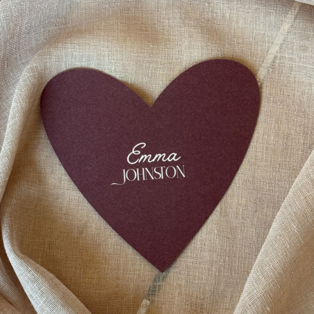 Burgundy heart wedding place name with white text