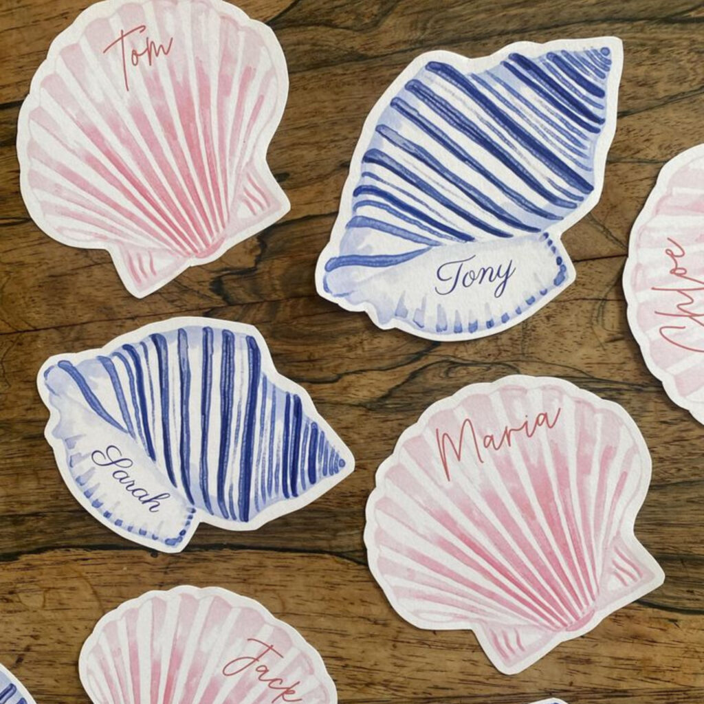 Pink and blue shell shaped wedding place cards with water colour design 